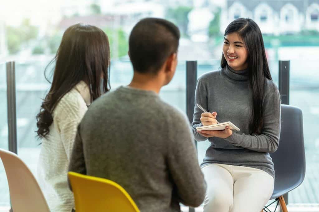 Asian woman professional psychologist doctor giving the consult to lovers patients