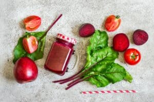 Detox drink Of beets, tomatoes and apples. Red smoothies And ingredients, detox concept.